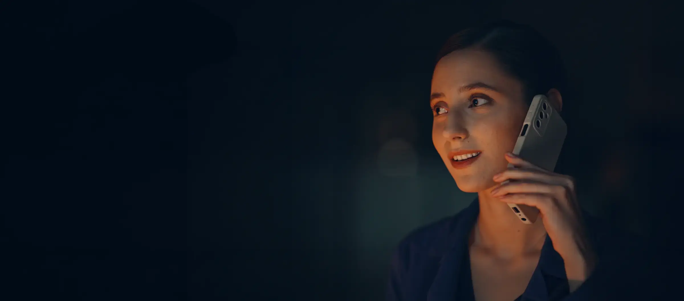 A woman on a phone call at night