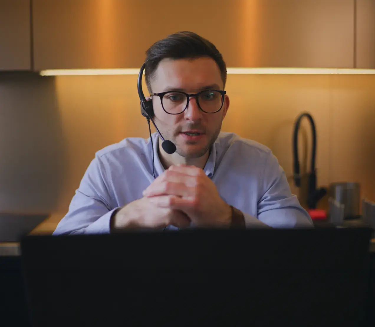 An admissions counselor wearing a headset on a call