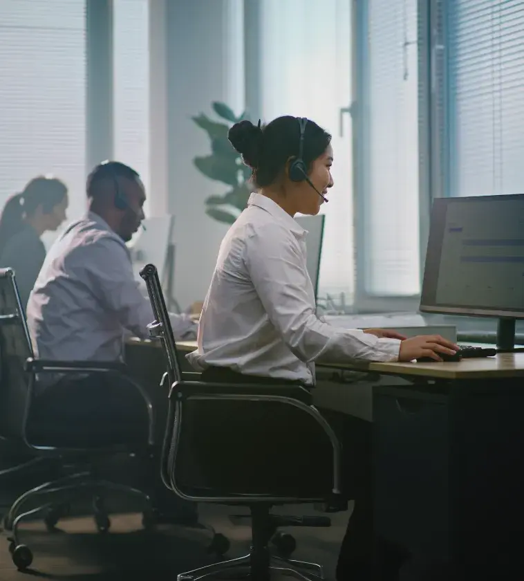 Admissions staff wearing headsets at their desks