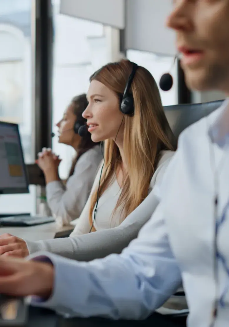 Admissions staff wearing headsets at their desks