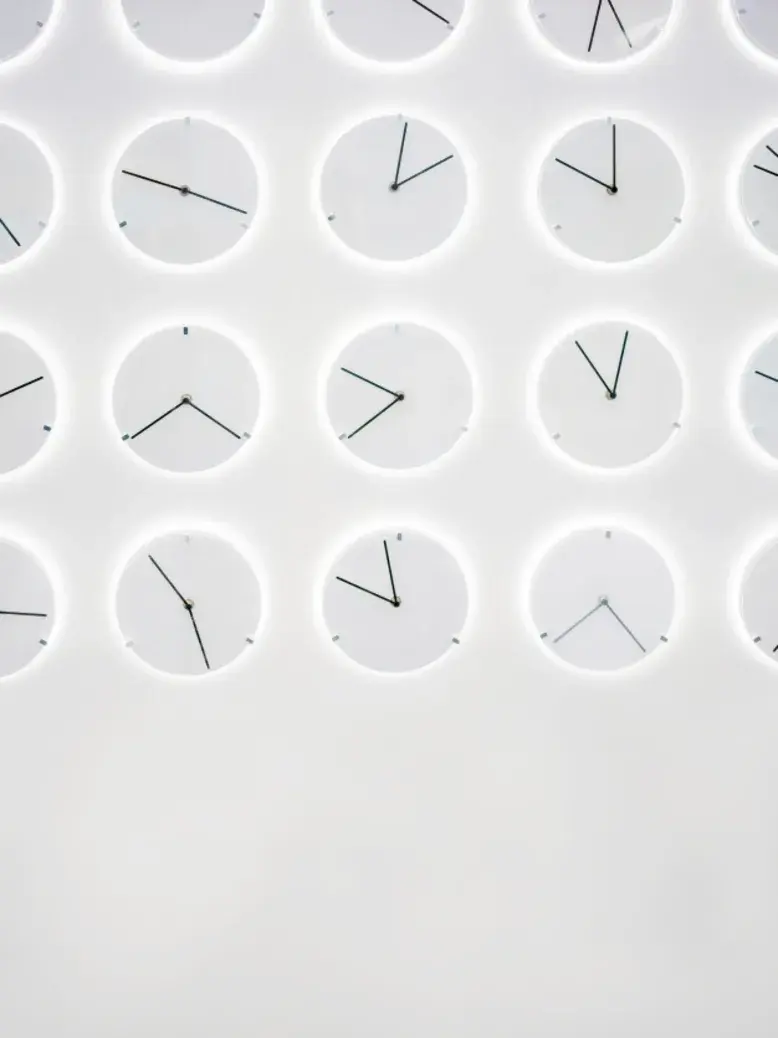 A wall of clocks showing different times